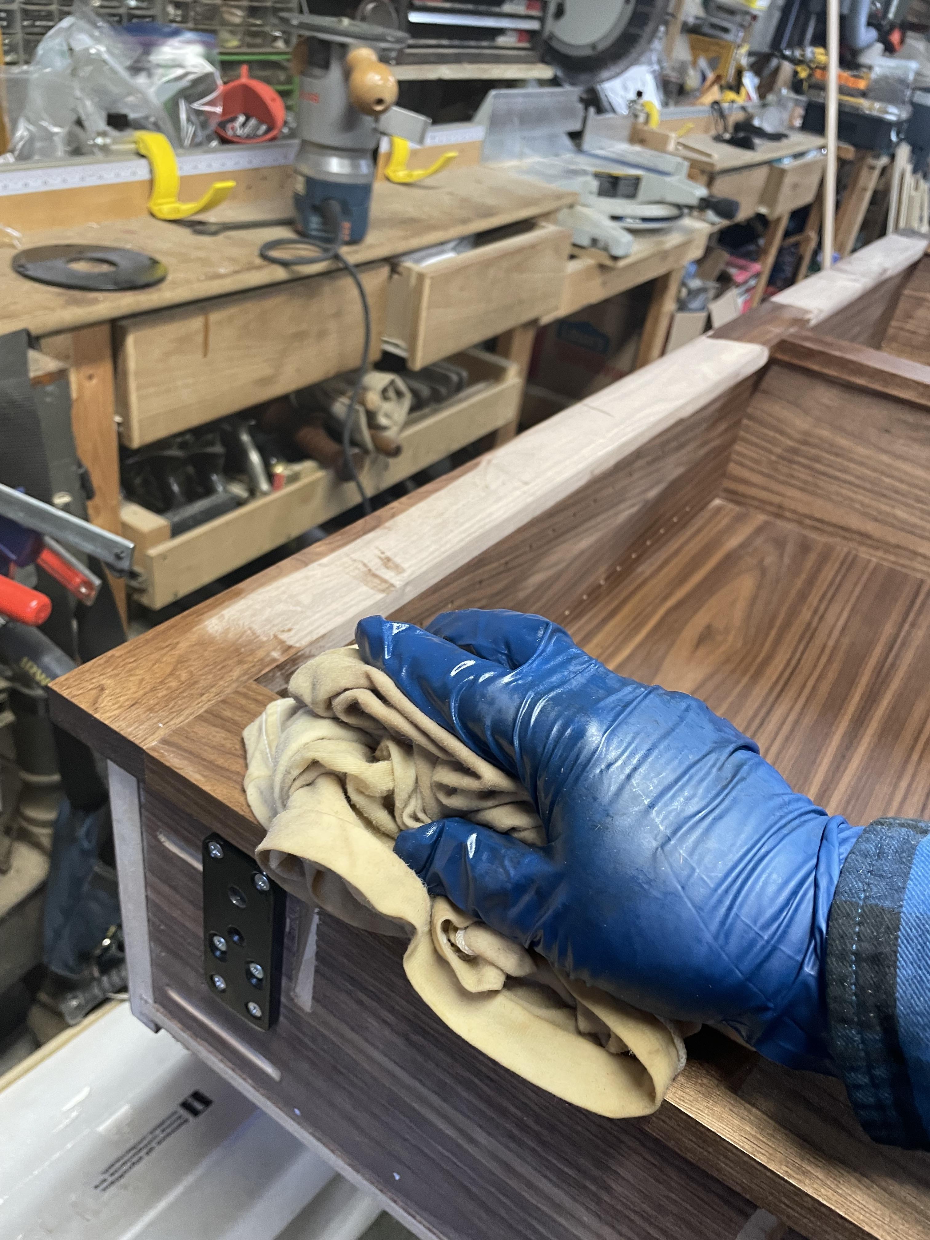 Applying wipe-on oil finish to Murphy Door.