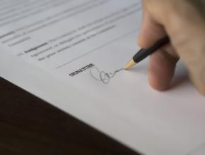 Signing paperwork - Pexels