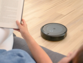 Robot vacuuming while person reads