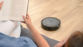 Robot vacuuming while person reads