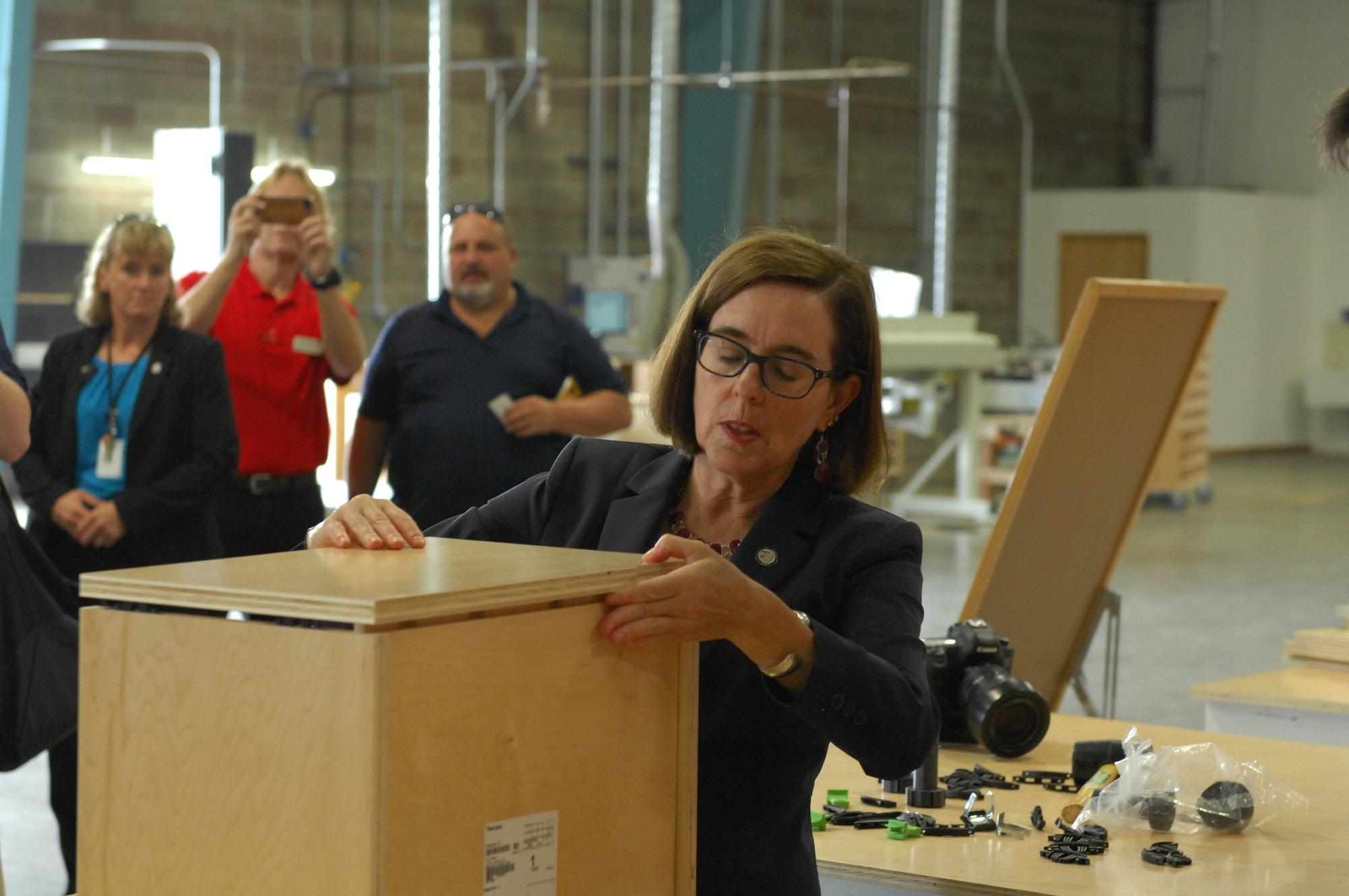 1709FDMCcabinotch4-Governor-Kate-Brown-assembling-cabinotch-box.jpg
